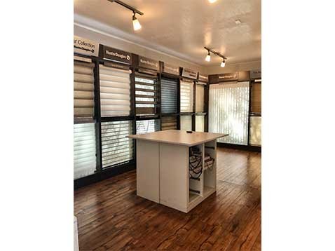Store interior showcasing several different types of window coverings